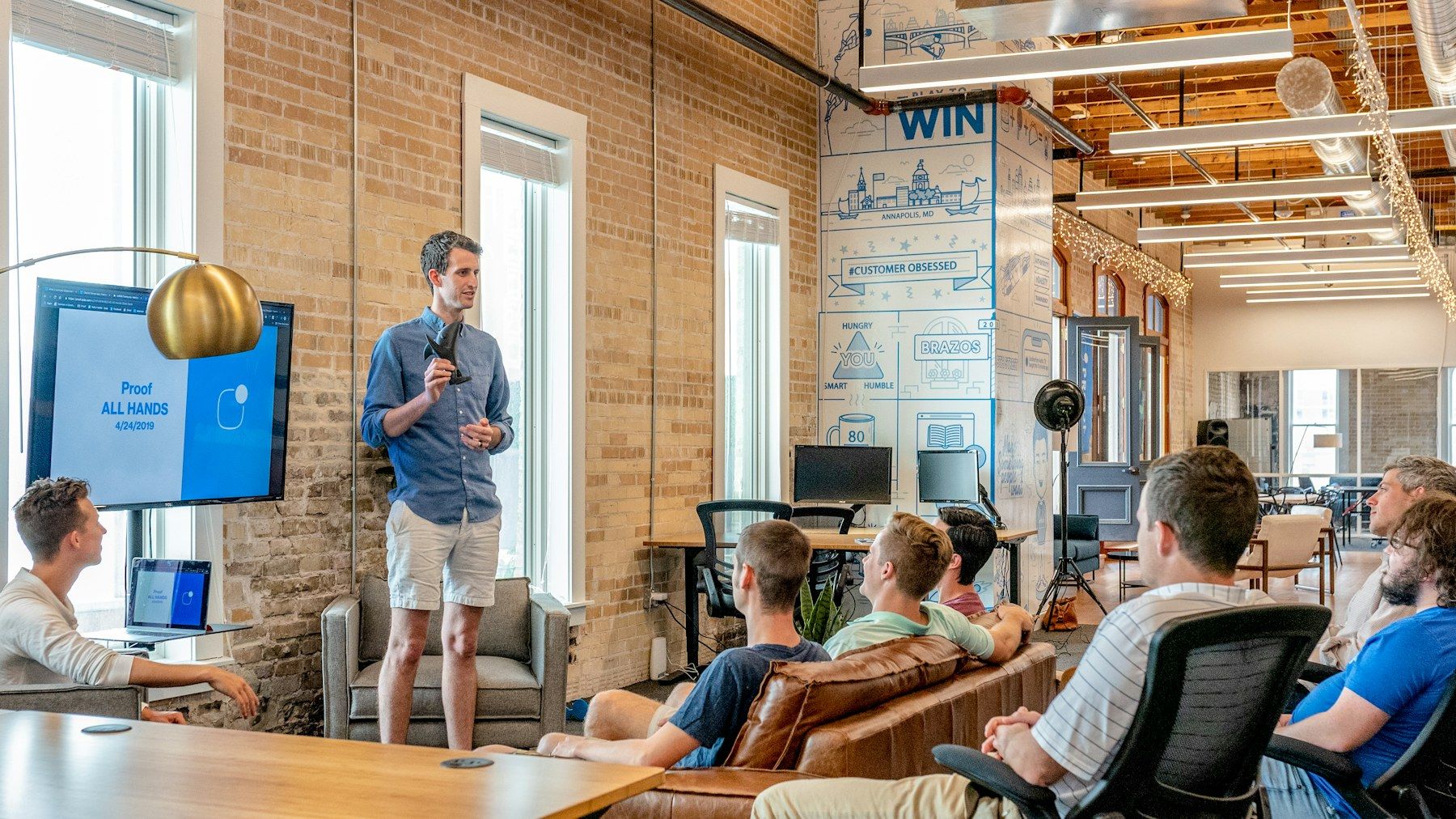 A founder presenting to a small team in a bright start-up office