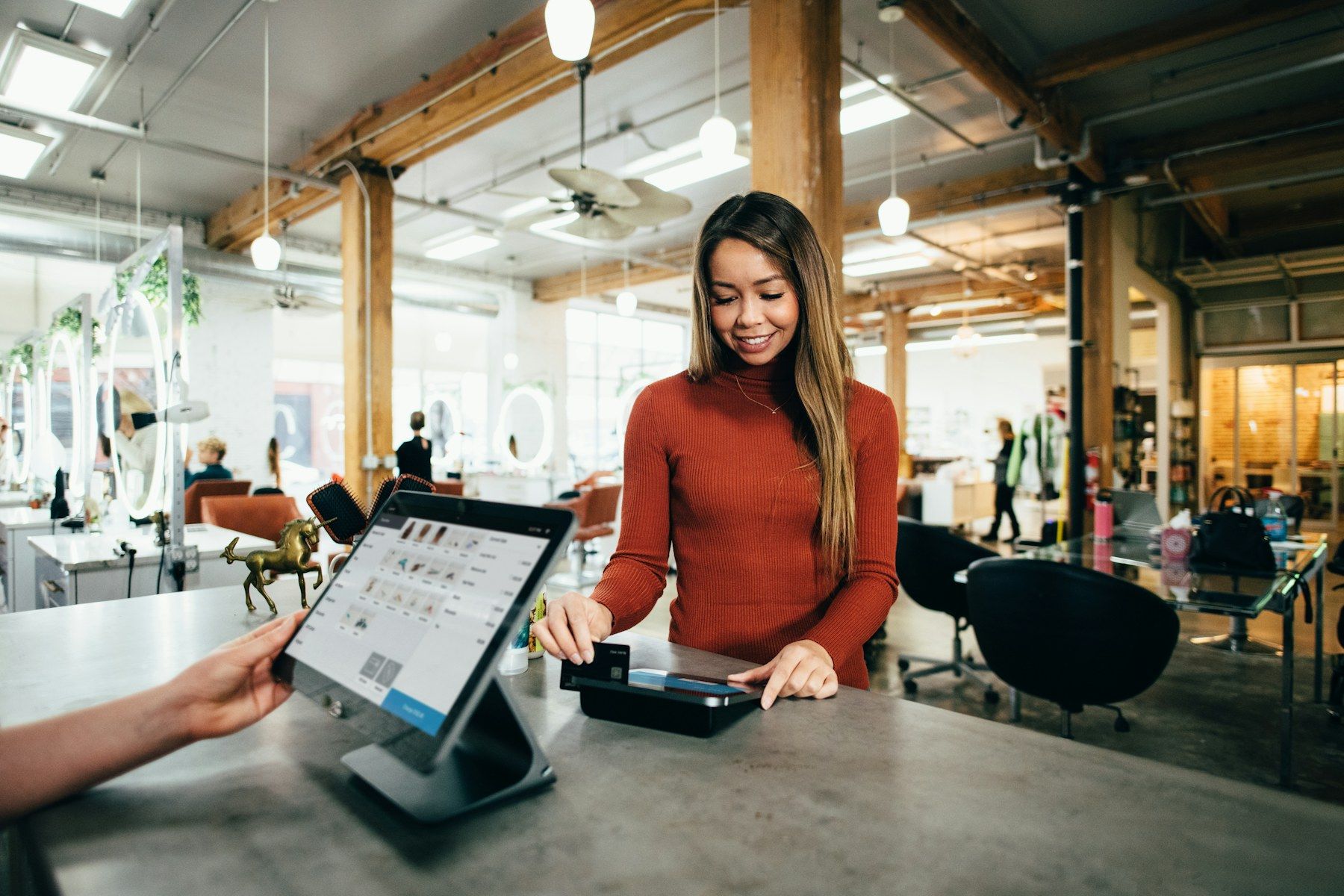 A business owner taking a card payment at her counter
