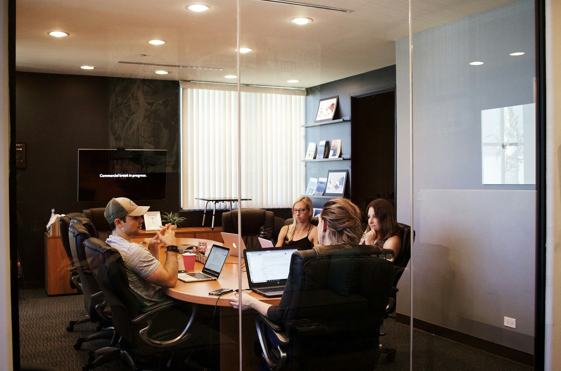 A small team in discussion around a meeting-room table