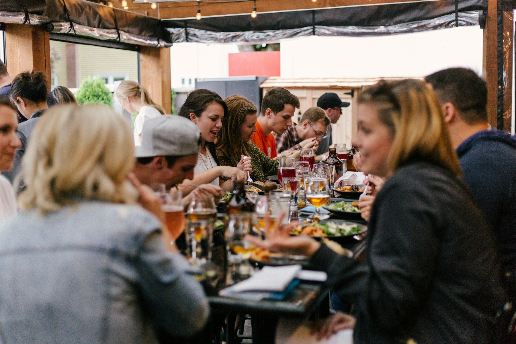 A diverse group of people talking together around a long table