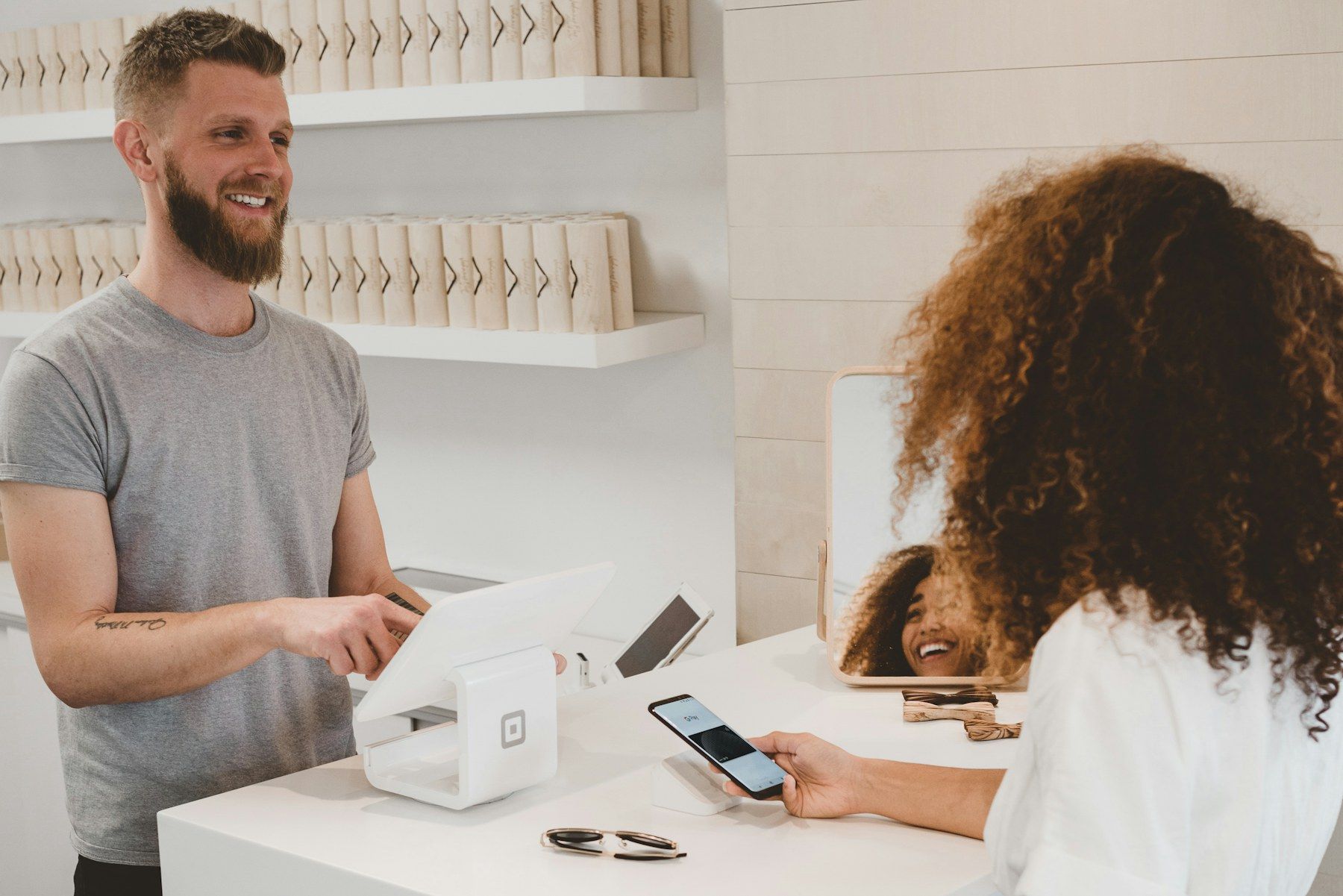 A shop owner serving a customer at the counter